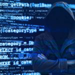 Hacker without face surrounded by source code