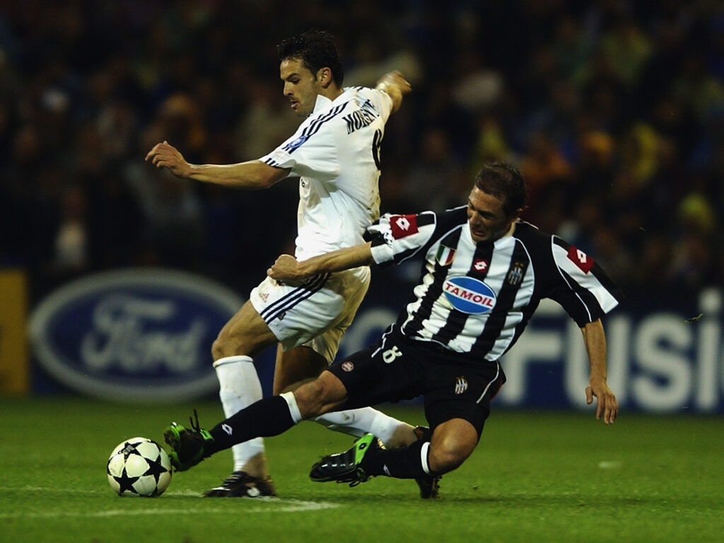 Fernando Morientes of Real Madrid is tackled by Antonio Conte of Juventus